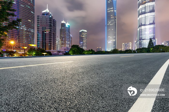 Shanghai modern commercial buildings and asphalt highway at night,China.