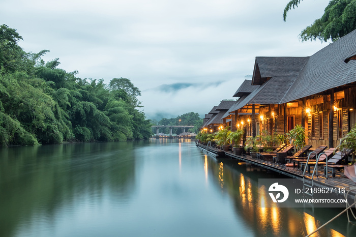 Resort wooden house floating and mountain fog on river kwai