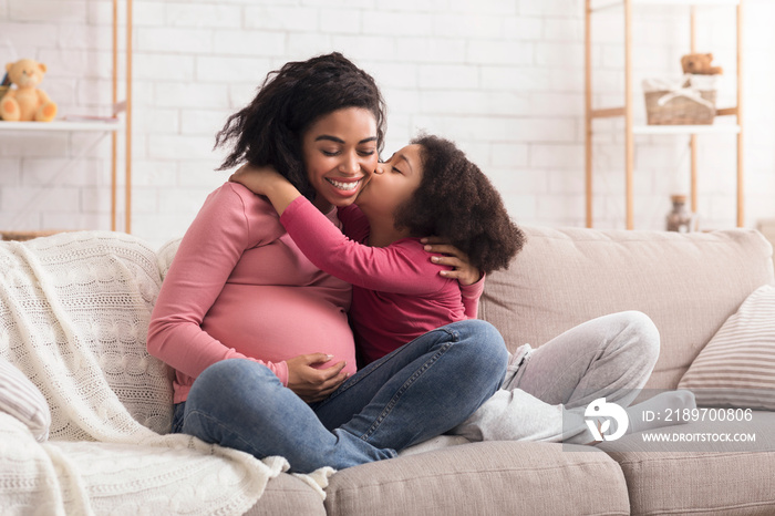 Loving Little Girl Kissing And Embracing Her Pregnant Afro Mom