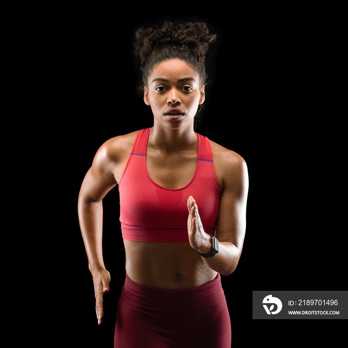 Strong athletic afro woman running over black background