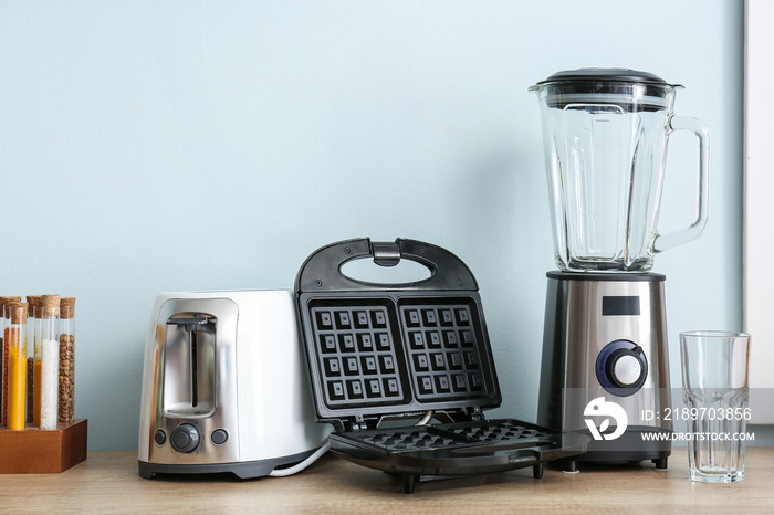 Different household appliances on table in kitchen