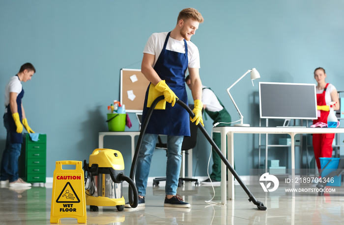 Team of janitors cleaning office