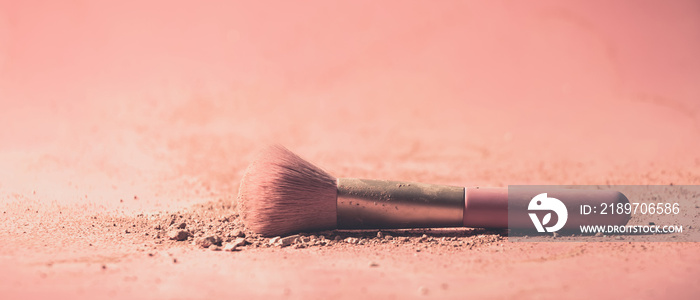 Make up brushes with powder on pink background