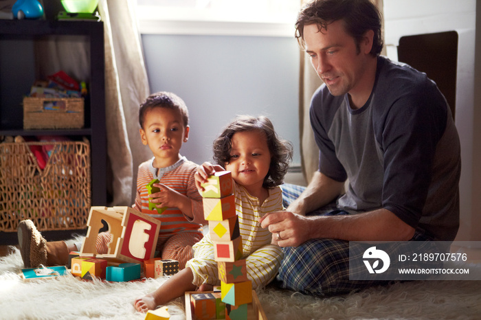 Father with his children playing at home