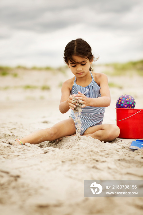 Little girl (6-7) playing on beach