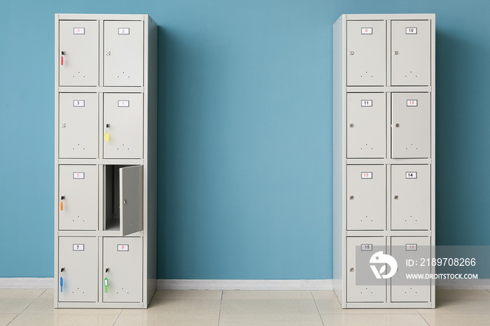 Modern lockers near blue wall