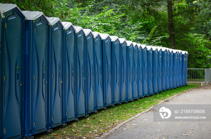 Bio public wc at a park. Locked, portable chemical lavatories. Nature background.