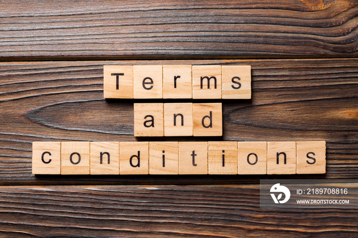 Terms and conditions word written on wood block. Terms and conditions text on wooden table for your 