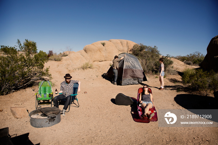 Four people at camp in desert