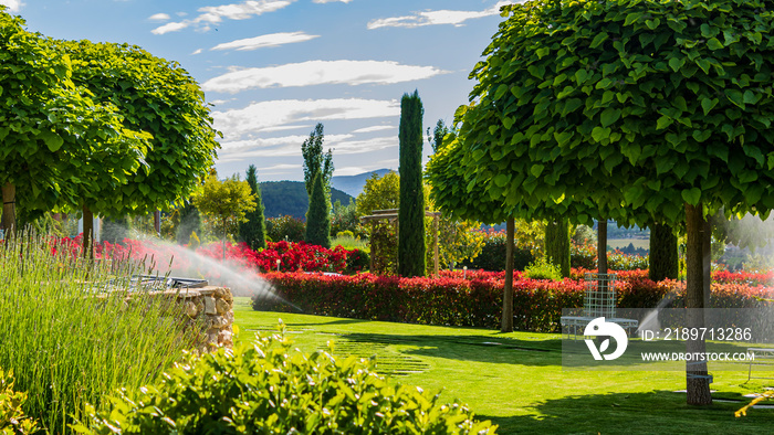 Wedding garden on a sunny day and the sprinklers watering.