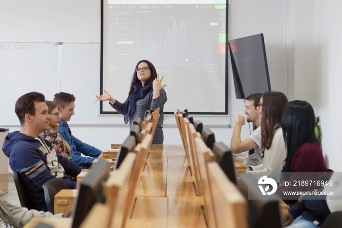 Female professor explain lesson to students and interact with them in the classroom.Helping a studen