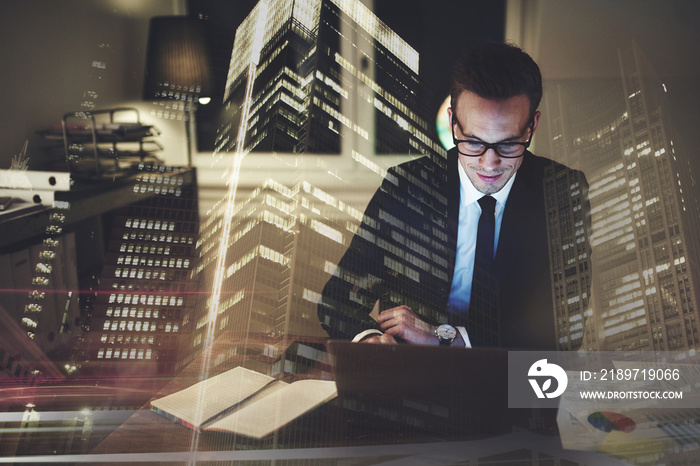 Optimistic businessman working on laptop