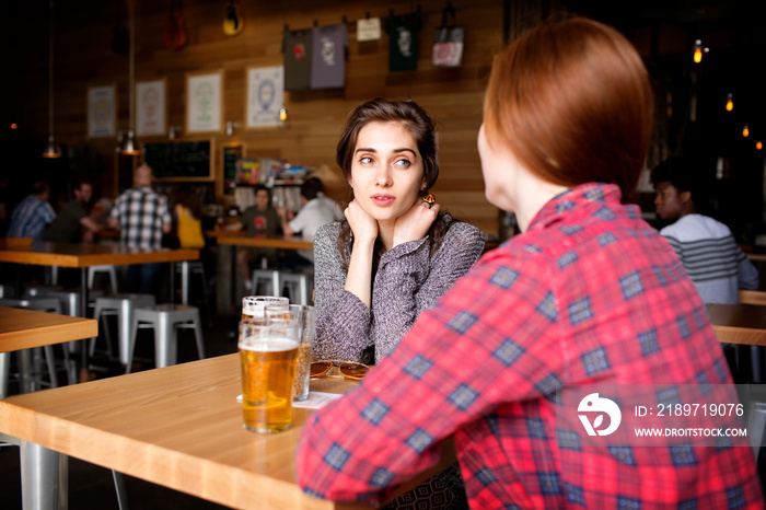 Young women sitting in brewery