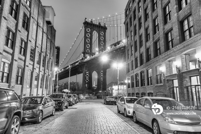 Night view of the Empire State Building through the pylons of Manhattan Bridge. View from Washington