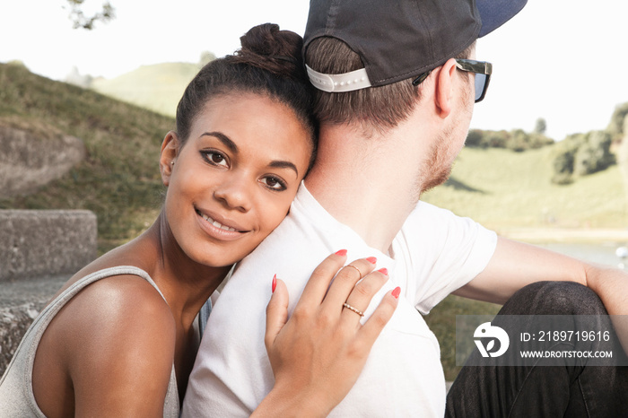 Young woman hugging boyfriend