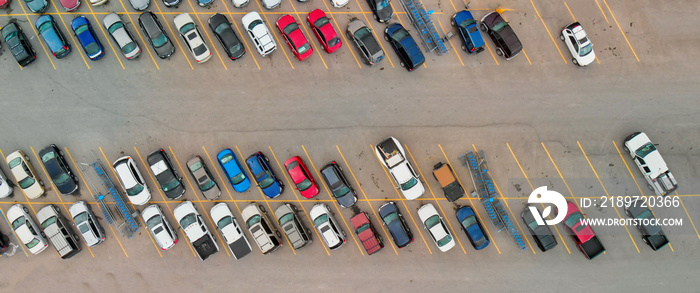 Aerial view of cars at large outdoor parking lots, USA. Outlet mall parking congestion and crowded p