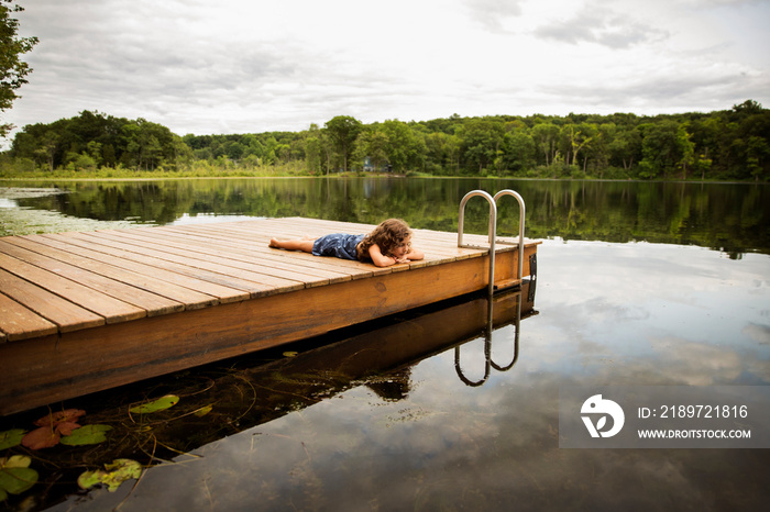 Girl relaxing on wooden pier