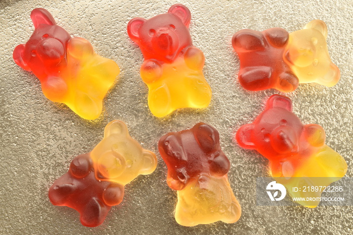 Several sweet jelly candies on a metal tray, close-up, top view.