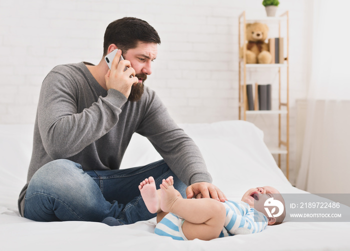 Little babby suffering from colic, dad calling to doctor