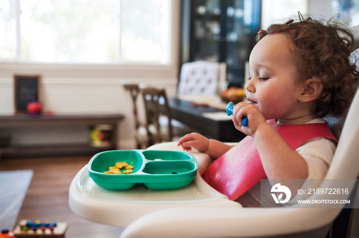 Baby girl (12-17 months) eating snack