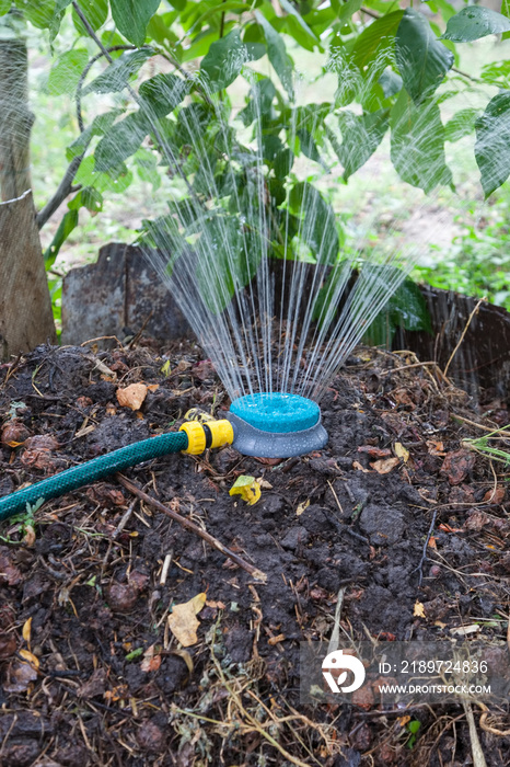 Humidification compost pile using sprinkler