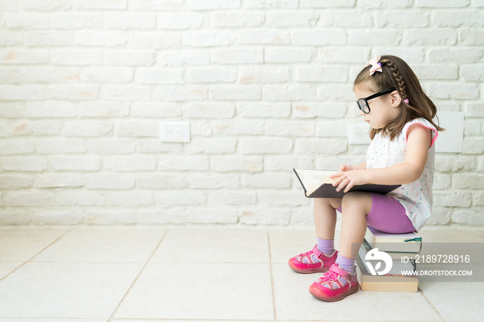 Kid Reading Textbooks At Living Room