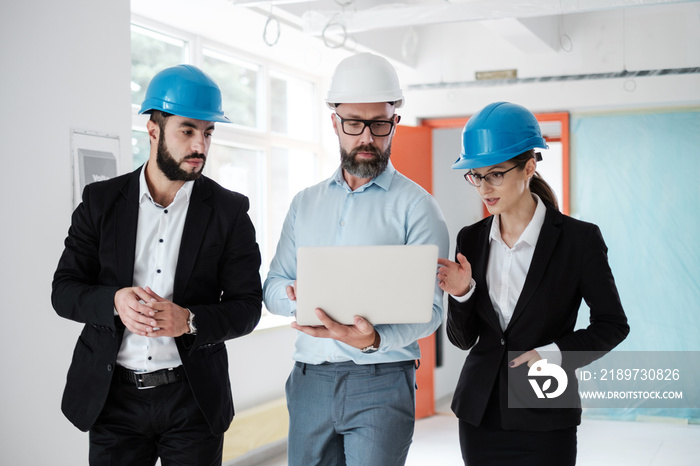 Engineers in hardhats have conversation