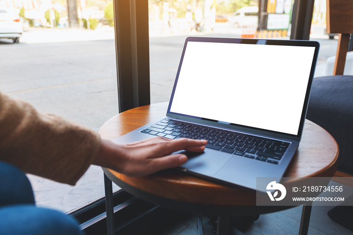 Mockup image of a woman using and touching on laptop touchpad with blank white desktop screen