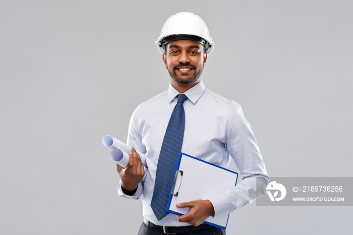 architecture, construction business and building - smiling indian architect or businessman in helmet