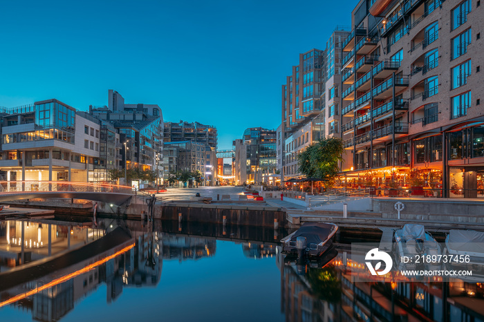 Oslo, Norway. Night View Embankment And Residential Multi-storey Houses In Aker Brygge District. Sum