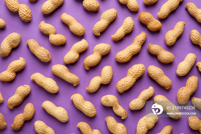 Tasty peanuts on color background