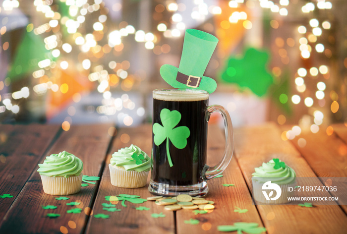 st patricks day, holidays and celebration concept - glass of dark draft beer with shamrock, green cu