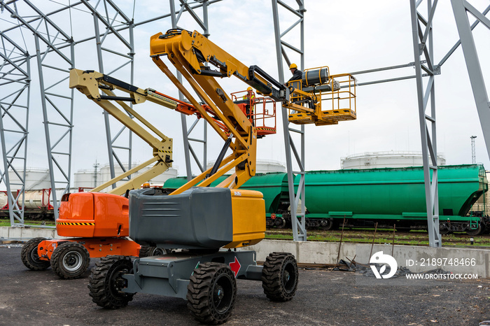 Lift with platform work in warehouse hangar construction field.