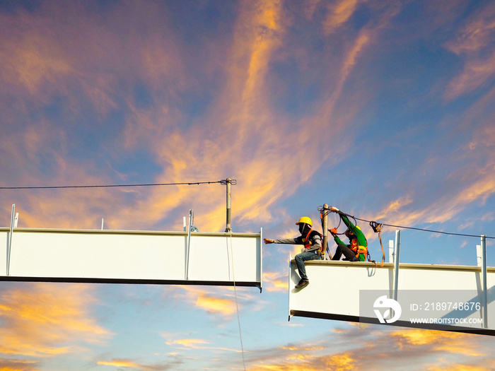 Man Working on the Working at height on construction site with blue sky