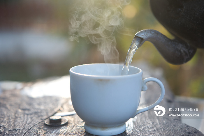 Pour hot water with smoke from a kettle.