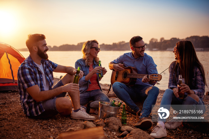 Young people enjoying in music on camping trip