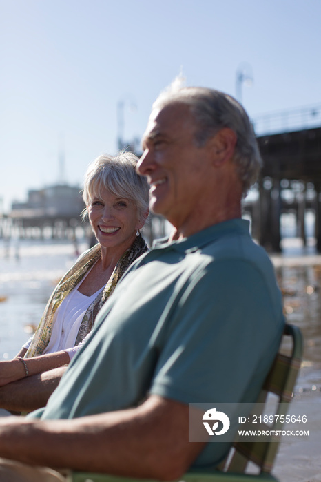 Happy senior couple relaxing on sunny beach