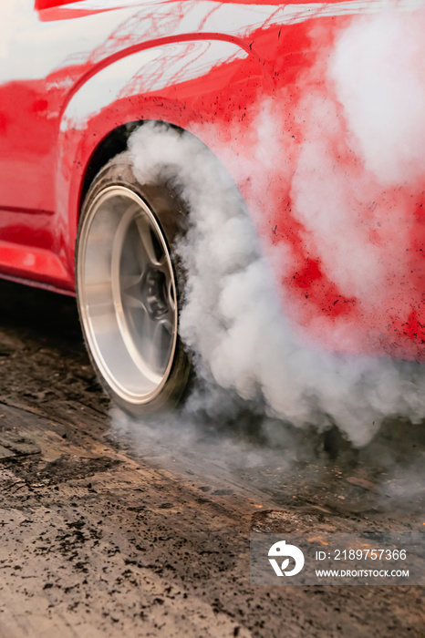 Drag racing car burns rubber off its tires in preparation for the race