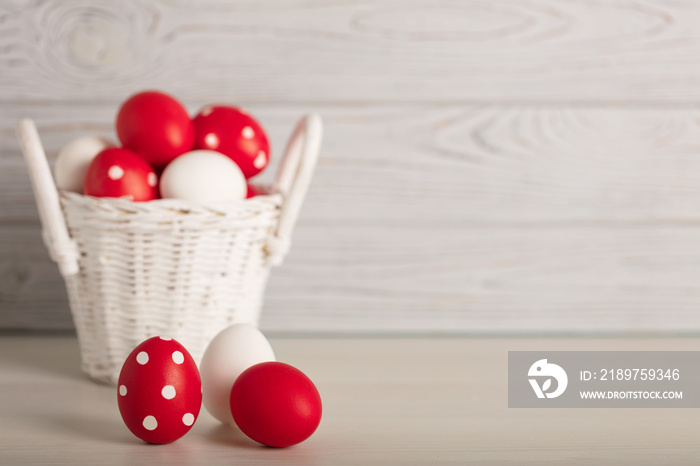 Happy Easter! Painted Easter eggs - red, white and red with white polka dots on a gray wooden backgr