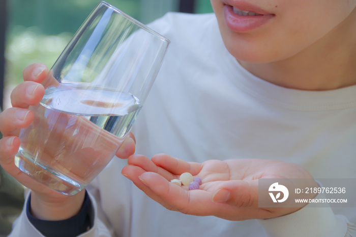 錠剤を飲む女性