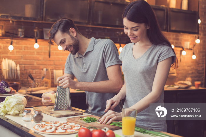 Young couple cooking in kitchen