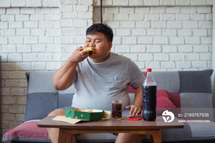 Fat men are happy with eating pizza and soft drinks.