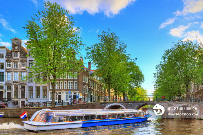 Canal cruise boat goes under the bridge over the Leidse canal at the Patricians or Lords canal (He