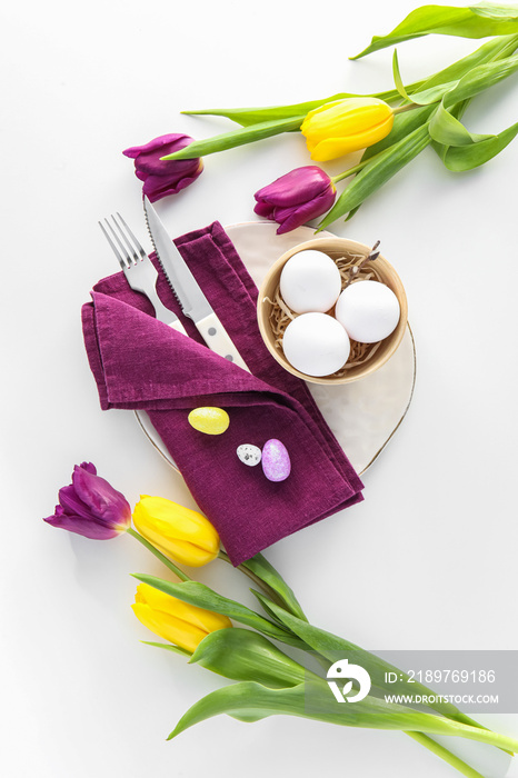 Beautiful Easter table setting with tulip flowers on white background