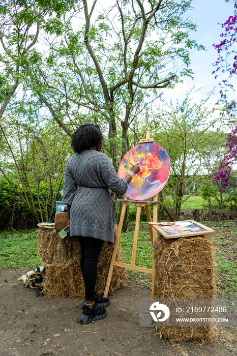 young woman painting outdoors on a cloudy day