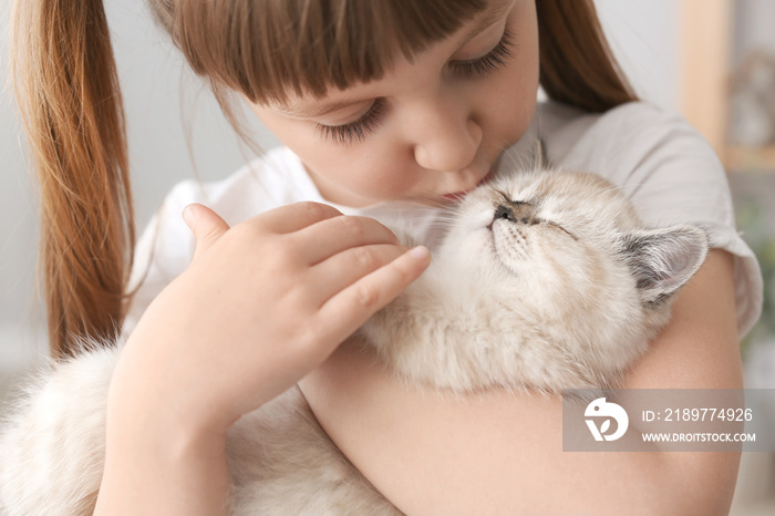 Girl with cute fluffy kitten at home