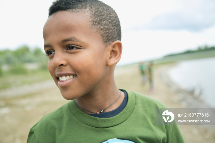 African American elementary student standing by the water