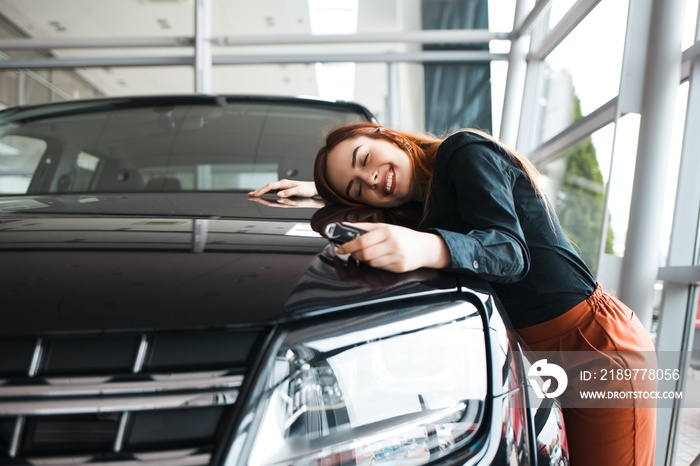 快乐的女人拥抱她的新车