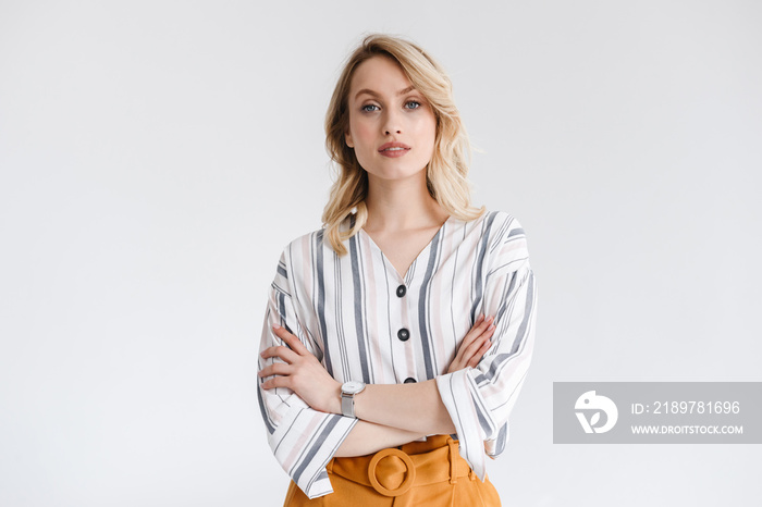 Portrait of blond nice woman wearing casual clothes looking at camera with arms crossed