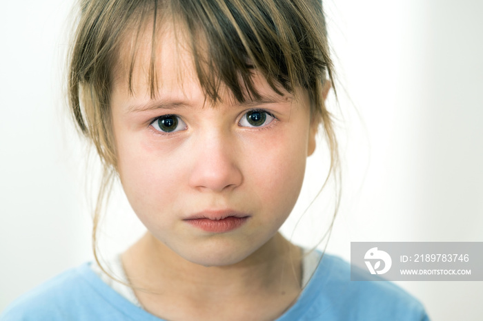 Closeup portrait of sad crying child girl.